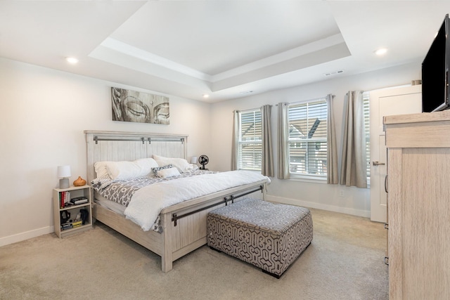 bedroom with a tray ceiling, light colored carpet, baseboards, and recessed lighting