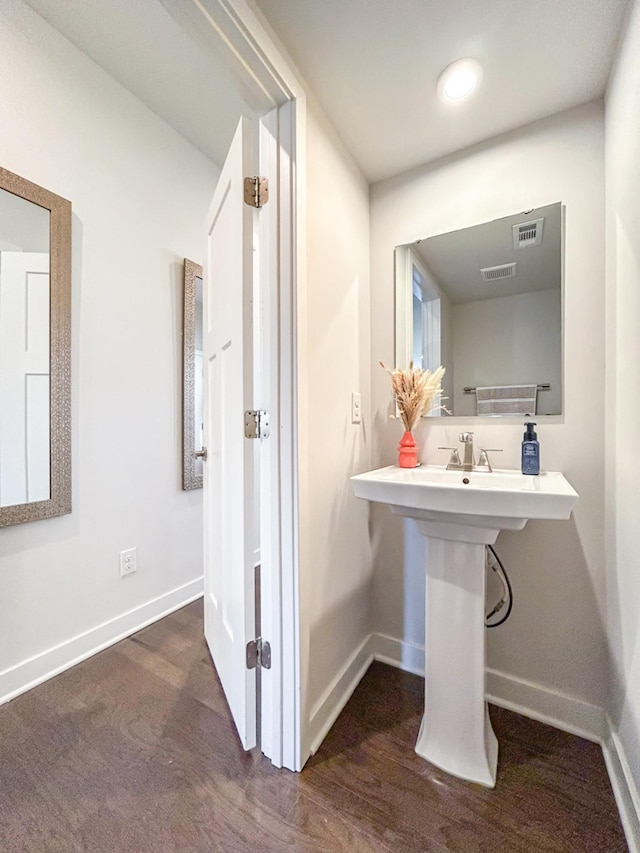 bathroom featuring baseboards and wood finished floors