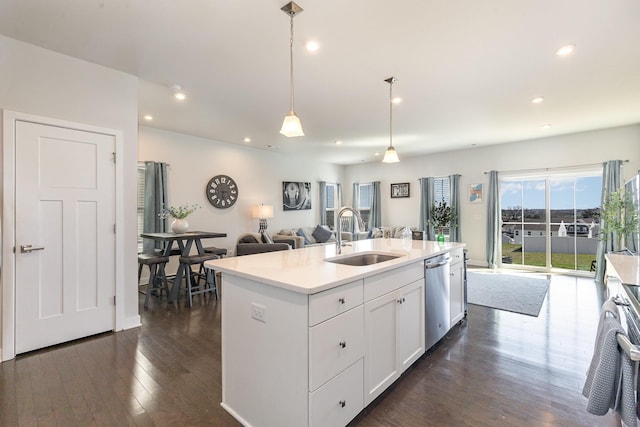 kitchen featuring a sink, stainless steel appliances, open floor plan, dark wood-style flooring, and recessed lighting
