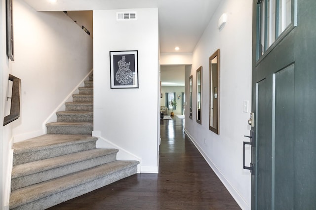 entryway with stairs, dark wood-type flooring, baseboards, and recessed lighting
