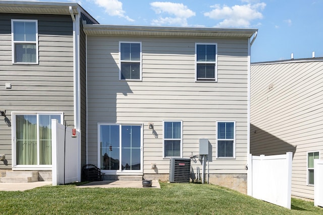 back of house with central AC unit