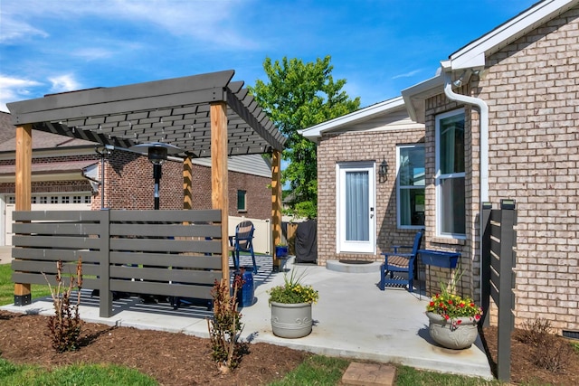 view of patio / terrace featuring a pergola and fence