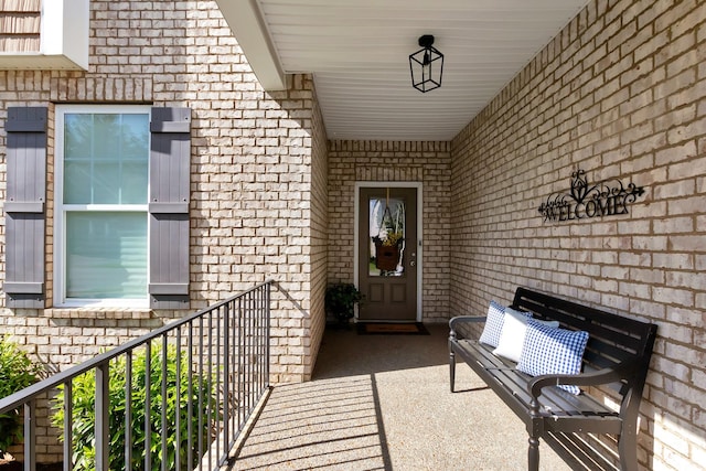 doorway to property featuring brick siding