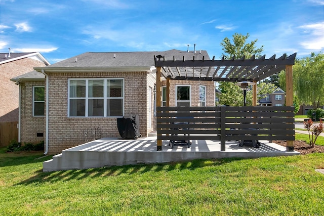 back of property with brick siding, a pergola, a yard, and a patio