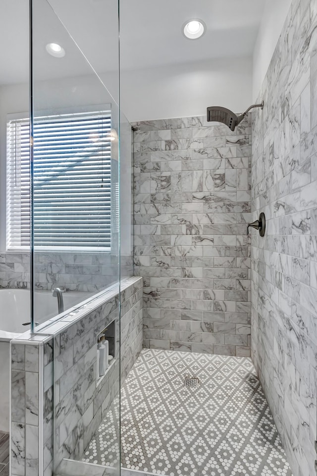 full bathroom with a tile shower and recessed lighting