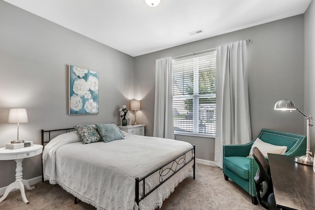 bedroom featuring light colored carpet and baseboards
