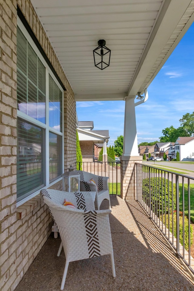 balcony featuring a porch and a residential view