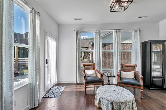 sitting room with dark wood-style flooring and baseboards