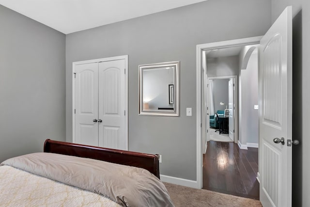 bedroom with a closet and baseboards