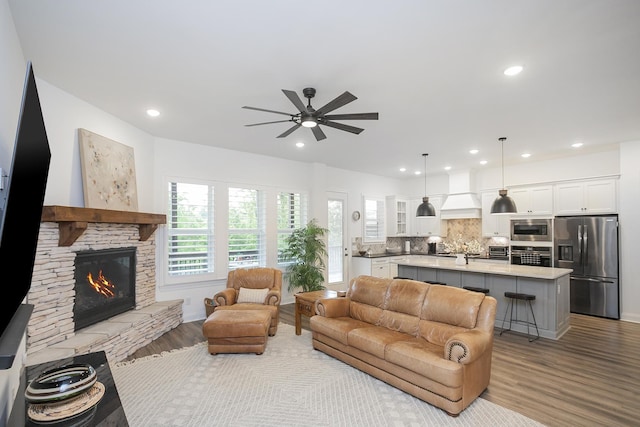 928 Tynan Way, Nolensville, TN 37135 - living area featuring wood finished floors, ceiling fan, a stone fireplace, and recessed lighting