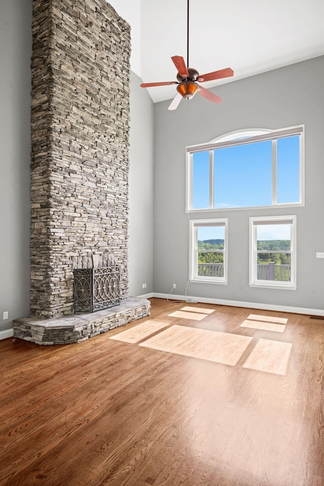 1709 Wildlife Trl, Kingston Springs, TN 37082 - unfurnished living room featuring high vaulted ceiling, baseboards, wood finished floors, ceiling fan, and a fireplace