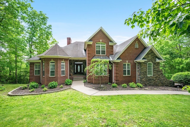 1709 Wildlife Trl, Kingston Springs, TN 37082 - view of front of property with a front lawn, a chimney, roof with shingles, and brick siding