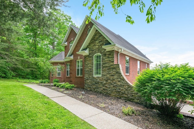 1709 Wildlife Trl, Kingston Springs, TN 37082 - view of home's exterior with stone siding, a yard, brick siding, and a shingled roof