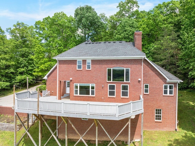 1709 Wildlife Trl, Kingston Springs, TN 37082 - back of property with a chimney, a deck, brick siding, and a shingled roof