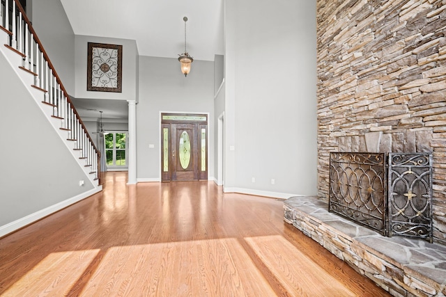 1709 Wildlife Trl, Kingston Springs, TN 37082 - entryway with wood finished floors, stairway, baseboards, a high ceiling, and ornate columns