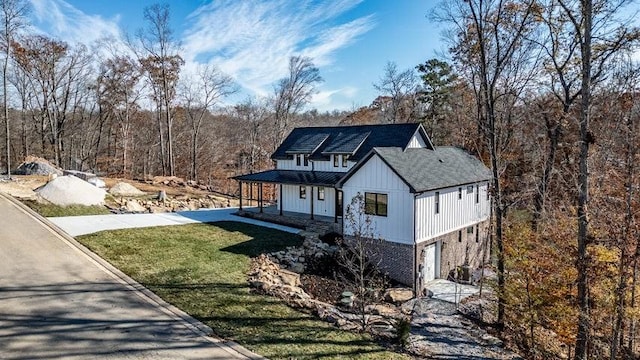 463 Waterfront Way, Ten Mile, TN 37880 - modern farmhouse style home with a porch, a front yard, board and batten siding, and driveway