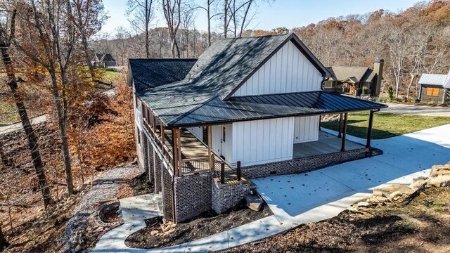 463 Waterfront Way, Ten Mile, TN 37880 - view of side of property with board and batten siding, a standing seam roof, a porch, metal roof, and a shingled roof