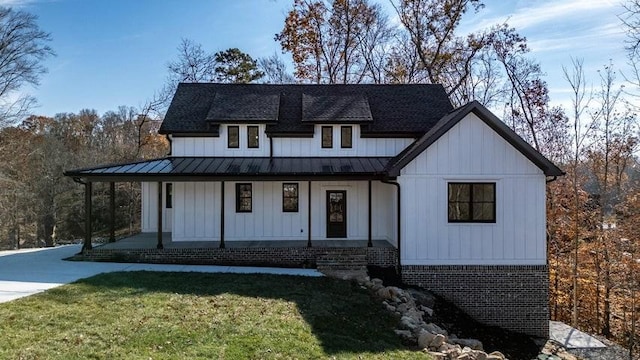 463 Waterfront Way, Ten Mile, TN 37880 - modern farmhouse style home featuring a standing seam roof, board and batten siding, covered porch, and a front lawn