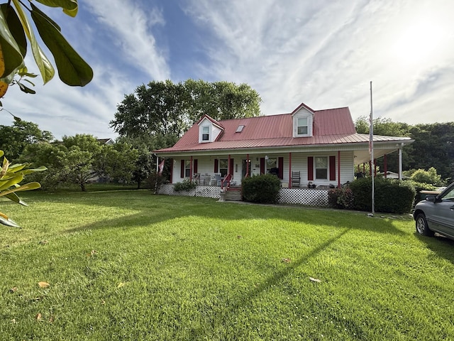 farmhouse inspired home with a porch, a front lawn, and metal roof