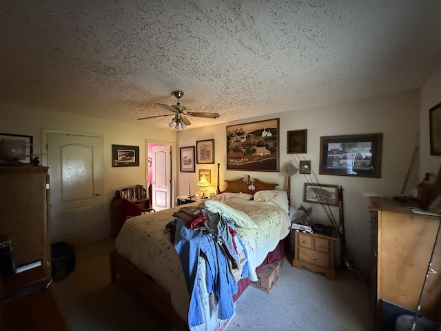 bedroom with a textured ceiling, ceiling fan, and carpet flooring