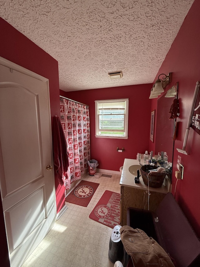 full bath featuring vanity, a textured ceiling, tile patterned floors, and curtained shower