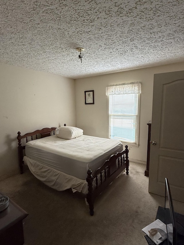 carpeted bedroom featuring a textured ceiling