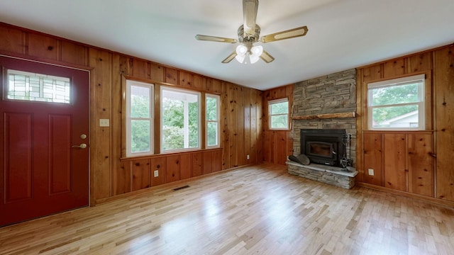 251 Old Sr 48, Centerville, TN 37033 - unfurnished living room featuring healthy amount of natural light, wood finished floors, wooden walls, a ceiling fan, and baseboards