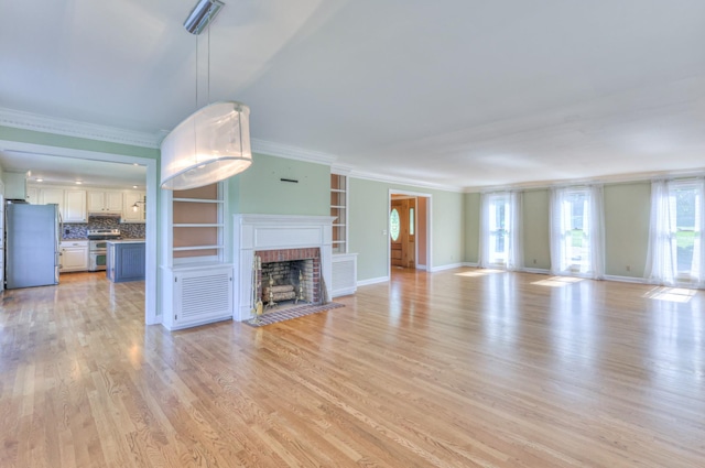 unfurnished living room with ornamental molding, a fireplace, light wood-style floors, and baseboards