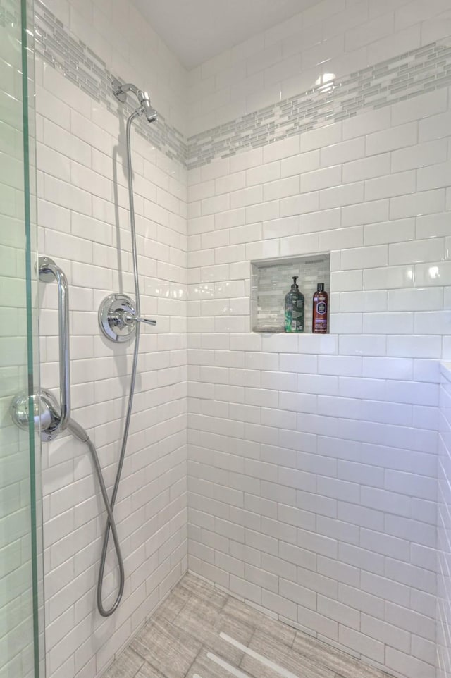 full bathroom with tiled shower