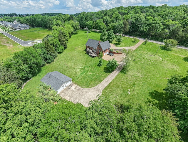 aerial view of property and surrounding area with a forest