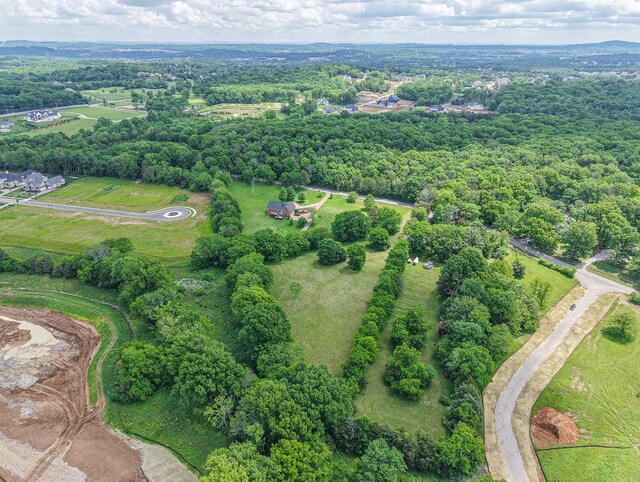 aerial view of property's location featuring a forest