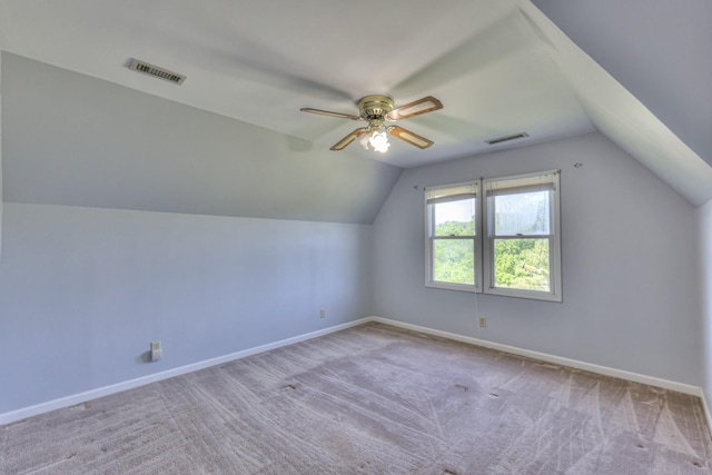 bonus room featuring lofted ceiling, carpet flooring, ceiling fan, and baseboards