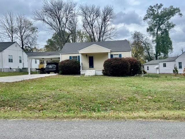 view of front of house featuring concrete driveway and a front yard