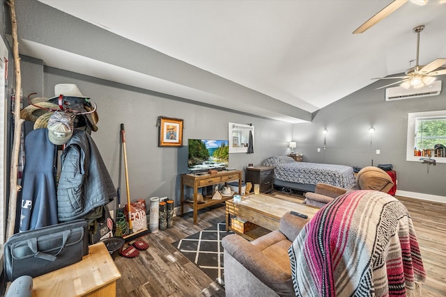 bedroom featuring vaulted ceiling, wood finished floors, a wall mounted air conditioner, and baseboards