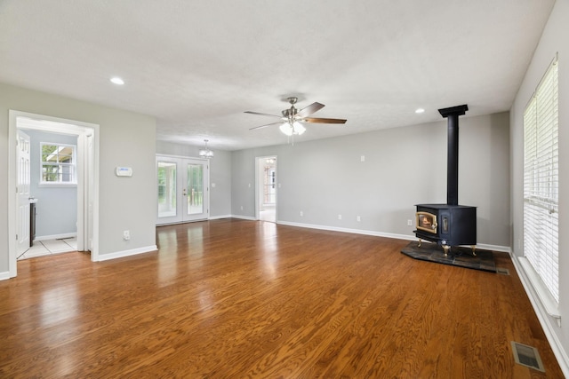 2907 York Rd, Pleasant View, TN 37146 - unfurnished living room with ceiling fan, a wood stove, wood finished floors, baseboards, and recessed lighting