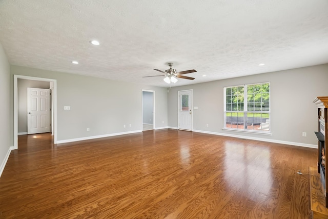 2907 York Rd, Pleasant View, TN 37146 - unfurnished living room with a fireplace, ceiling fan, recessed lighting, baseboards, and wood finished floors
