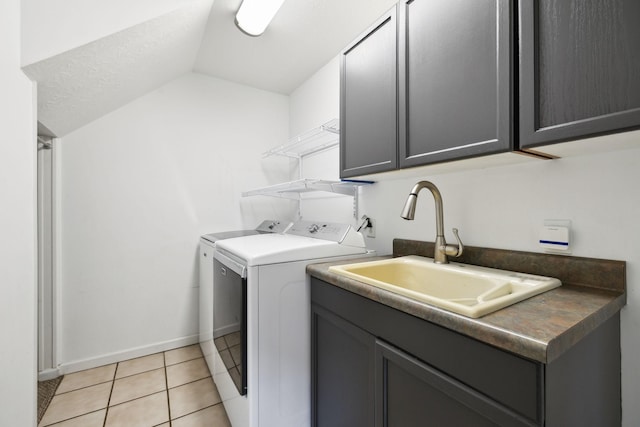 2907 York Rd, Pleasant View, TN 37146 - laundry area featuring washer and dryer, cabinet space, light tile patterned floors, and baseboards