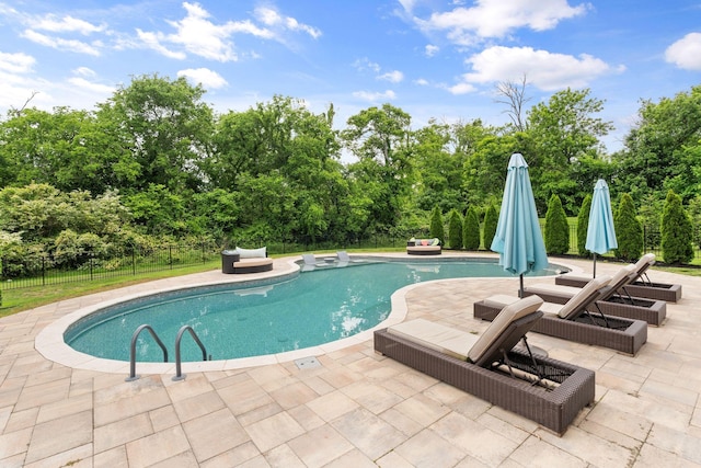 8027 Puddleduck Ln, Spring Hill, TN 37174 - view of swimming pool with a patio, fence, and view of scattered trees