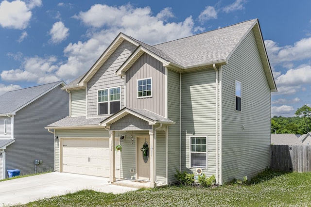 view of front of property featuring fence, board and batten siding, an attached garage, concrete driveway, and roof with shingles