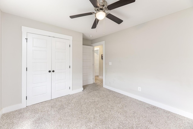 unfurnished bedroom with carpet floors, baseboards, a closet, and ceiling fan