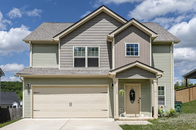 view of front of property featuring an attached garage, fence, driveway, and roof with shingles