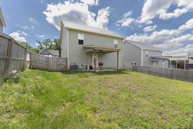 rear view of property featuring cooling unit and a ceiling fan
