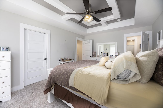 bedroom featuring light carpet, a raised ceiling, ceiling fan, and ensuite bathroom