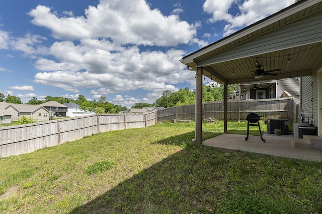 view of yard with a ceiling fan and a patio