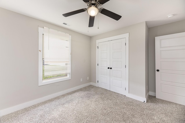 unfurnished bedroom featuring carpet floors, a closet, and baseboards