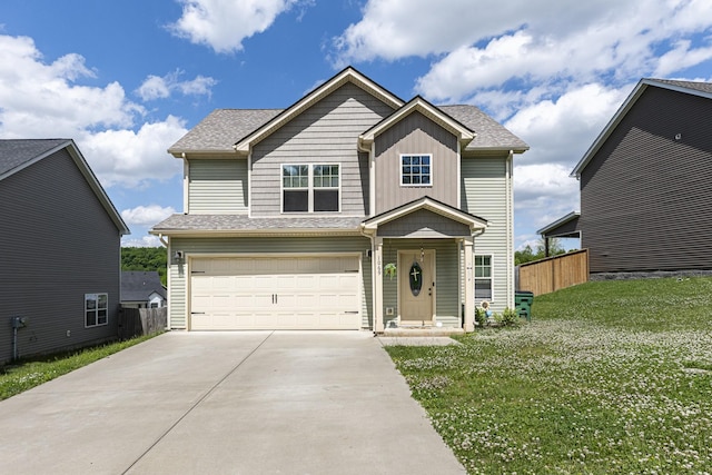 view of front of home with driveway, an attached garage, and a shingled roof