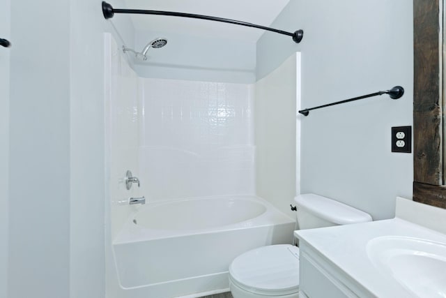 bathroom with toilet, vanity, and shower / washtub combination