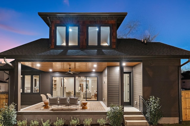 back of house featuring a ceiling fan, roof with shingles, and outdoor dining space