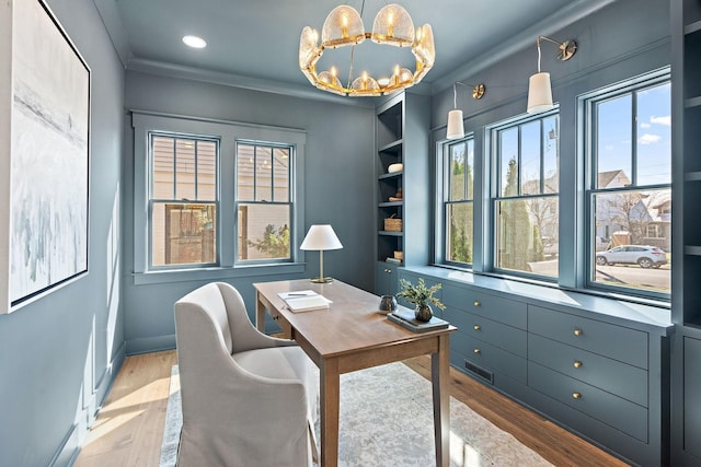 home office with healthy amount of natural light, light wood-style floors, a chandelier, recessed lighting, and ornamental molding