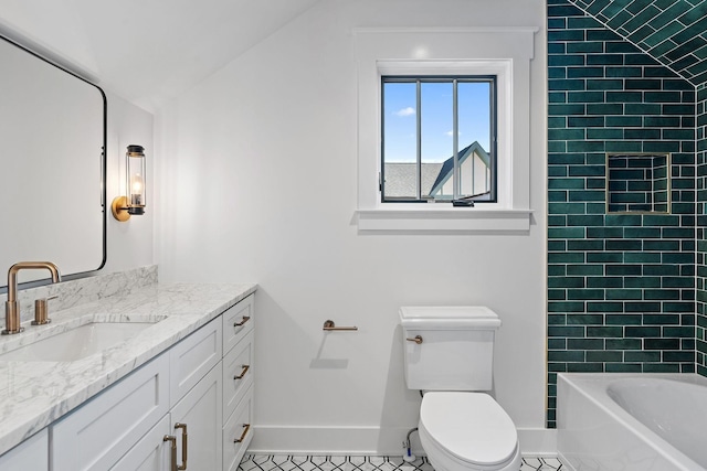 bathroom with baseboards, toilet, vanity, tile patterned flooring, and vaulted ceiling